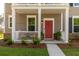 Inviting front porch with a red door, white railing, and cozy seating area at 1417 Roustabout Way, Charleston, SC 29414