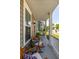 Cozy front porch offers outdoor seating with decorative pillows and neighborhood views at 1417 Roustabout Way, Charleston, SC 29414