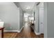 Open hallway with hardwood floors and a stylish table with decorative lamps at 1417 Roustabout Way, Charleston, SC 29414