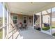 Cozy screened-in porch with lights, table, and chairs for relaxing evenings and outdoor dining at 1417 Roustabout Way, Charleston, SC 29414