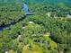 Aerial shot of the property with river access, highlighting the home's serene and wooded surroundings at 150 Riverbend Ln, Ridgeville, SC 29472