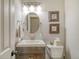 Cozy half bath with a modern vanity, oval mirror, and stylish decor at 150 Riverbend Ln, Ridgeville, SC 29472