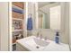 Bright bathroom with modern vanity, brushed nickel faucet, and open shelving for storage at 150 Riverbend Ln, Ridgeville, SC 29472