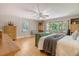 Well-lit bedroom featuring hardwood floors, a ceiling fan, and a view of the backyard at 150 Riverbend Ln, Ridgeville, SC 29472