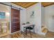 Dining area with an adjacent bathroom featuring a sliding barn door and modern fixtures at 150 Riverbend Ln, Ridgeville, SC 29472