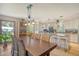 Dining area open to the kitchen with wood table, wicker chairs, and modern pendant lighting above the table at 150 Riverbend Ln, Ridgeville, SC 29472