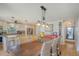 Dining area with table and wicker chairs situated between an open concept kitchen and living space at 150 Riverbend Ln, Ridgeville, SC 29472