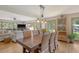 Open dining area with wicker chairs, wood table, and natural light from the windows surrounding the table at 150 Riverbend Ln, Ridgeville, SC 29472