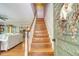 Inviting entryway with hardwood stairs, a decorative wreath, and a view of the living spaces at 150 Riverbend Ln, Ridgeville, SC 29472