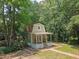 Charming home boasts a covered porch, surrounded by lush greenery and trees at 150 Riverbend Ln, Ridgeville, SC 29472