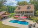 Charming home includes a pool, an outdoor kitchen, Adirondack chairs, and a full porch at 150 Riverbend Ln, Ridgeville, SC 29472