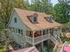 Stunning house with a large porch and wood railings at 150 Riverbend Ln, Ridgeville, SC 29472