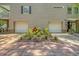 Exterior shot of two car garage with manicured front garden with floral decorations at 150 Riverbend Ln, Ridgeville, SC 29472
