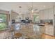 Spacious kitchen with a granite island, modern appliances, pendant lights, and light wood floors at 150 Riverbend Ln, Ridgeville, SC 29472