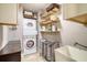 Well-organized laundry room with stacked washer and dryer and shelving at 150 Riverbend Ln, Ridgeville, SC 29472