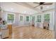 Large office space with desk areas and natural light, featuring multiple windows and a door to the outside at 150 Riverbend Ln, Ridgeville, SC 29472