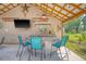 Outdoor bar with corrugated metal and concrete countertop, ceiling fan, and TV at 150 Riverbend Ln, Ridgeville, SC 29472