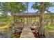 Wooden pavilion with benches and a metal roof sits on a pier over the water at 150 Riverbend Ln, Ridgeville, SC 29472