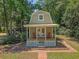 Exterior aerial of Playhouse with white trim, porch and matching outdoor furniture at 150 Riverbend Ln, Ridgeville, SC 29472