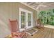 Cozy front porch with two rocking chairs, a door mat and wooded views at 150 Riverbend Ln, Ridgeville, SC 29472