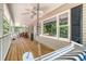 Inviting porch with swing and ceiling fan is perfect for relaxing and enjoying the outdoors at 150 Riverbend Ln, Ridgeville, SC 29472