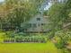 Two story home features a garden filled with plants and vegetables at 150 Riverbend Ln, Ridgeville, SC 29472