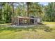 Charming outdoor shed featuring lattice work and an adjacent chicken coop at 150 Riverbend Ln, Ridgeville, SC 29472