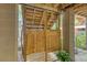 Outdoor shower stall with a wooden door and wood flooring at 150 Riverbend Ln, Ridgeville, SC 29472