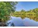Serene waterfront view with lush greenery and reflections in the calm water at 150 Riverbend Ln, Ridgeville, SC 29472
