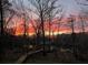 Scenic waterfront property with beautiful dock and boardwalk against a stunning sunset backdrop at 150 Riverbend Ln, Ridgeville, SC 29472