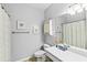 Bathroom featuring a white vanity, neutral wall paint, decorative artwork, and a shower/tub combination at 1600 Long Grove Dr # 1115, Mount Pleasant, SC 29464