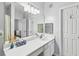 Bathroom showcasing a large mirror, white vanity with sink, overhead lighting, and access to other rooms at 1600 Long Grove Dr # 1115, Mount Pleasant, SC 29464