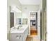 Bathroom featuring a white vanity with a large mirror and a view into the kitchen at 1600 Long Grove Dr # 1115, Mount Pleasant, SC 29464