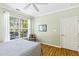 Well-lit bedroom with a large window, light green walls, and wood-look floors at 1600 Long Grove Dr # 1115, Mount Pleasant, SC 29464
