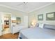 Bright bedroom featuring a ceiling fan, a dresser with a mirror, and light green walls at 1600 Long Grove Dr # 1115, Mount Pleasant, SC 29464