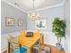Dining room with a wooden table, chairs, chandelier, and elegant wall decor at 1600 Long Grove Dr # 1115, Mount Pleasant, SC 29464
