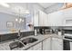 Updated kitchen with white cabinets, granite countertops, and stainless steel appliances at 1600 Long Grove Dr # 1115, Mount Pleasant, SC 29464