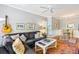 Open-concept living room with a gray sectional sofa, a guitar on the wall, and an adjacent dining area at 1600 Long Grove Dr # 1115, Mount Pleasant, SC 29464