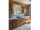 Traditional kitchen featuring wooden cabinets, stainless steel sink, and linoleum flooring at 1674 Garden St, Charleston, SC 29407