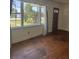 Cozy living room featuring a large window with backyard views and hardwood floors at 1674 Garden St, Charleston, SC 29407