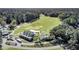 Aerial view of a golf course and clubhouse, surrounded by lush trees and well-maintained landscaping, showcasing the community at 173 Silver Cypress Cir, Summerville, SC 29485