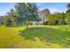 Expansive backyard with mature trees, lush lawn, and pond view at 173 Silver Cypress Cir, Summerville, SC 29485