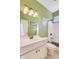 Bathroom with green walls featuring a white vanity, toilet, and shower/tub combo at 173 Silver Cypress Cir, Summerville, SC 29485