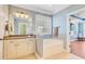 This bathroom features a large soaking tub, a granite countertop, and a window bringing in natural light at 173 Silver Cypress Cir, Summerville, SC 29485