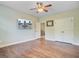 Inviting bedroom featuring a ceiling fan, wood floors, and a TV, perfect for relaxation and entertainment at 173 Silver Cypress Cir, Summerville, SC 29485