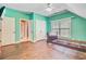 This empty bedroom features bright teal walls, a ceiling fan, a window, and several closets at 173 Silver Cypress Cir, Summerville, SC 29485