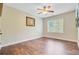 Bedroom featuring a ceiling fan, wood floors, and a sunny window, creating a cozy and inviting atmosphere at 173 Silver Cypress Cir, Summerville, SC 29485
