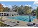 Beautiful community pool area with a covered pavilion, surrounding trees, and lounge chairs for relaxation at 173 Silver Cypress Cir, Summerville, SC 29485