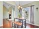 Bright dining area features hardwood floors, a chandelier, and views of the outdoors at 173 Silver Cypress Cir, Summerville, SC 29485