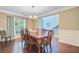 Spacious dining room boasts hardwood floors, chandelier, and natural light from a large window at 173 Silver Cypress Cir, Summerville, SC 29485